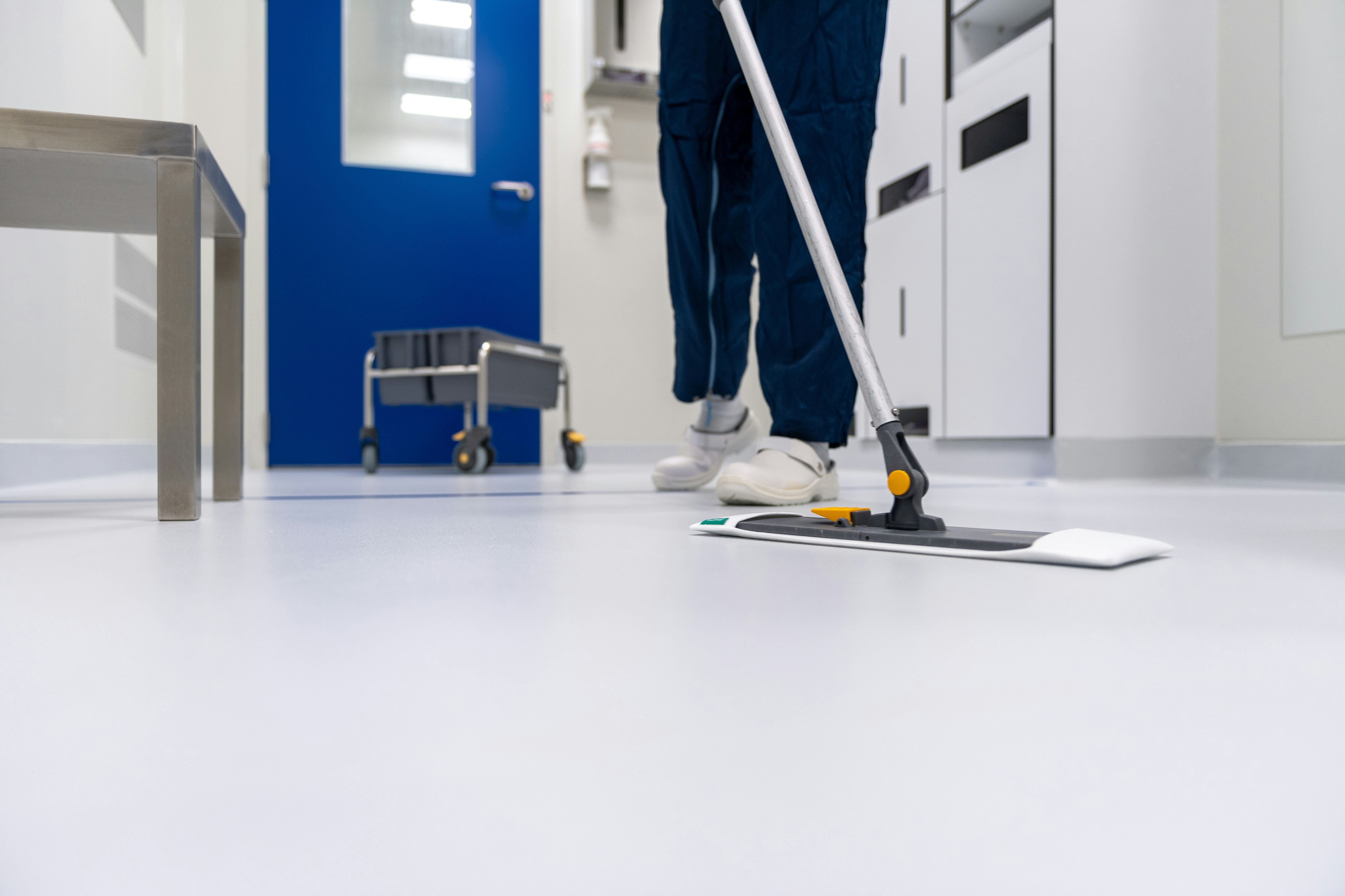 Home cleaning service professional vacuuming a living room