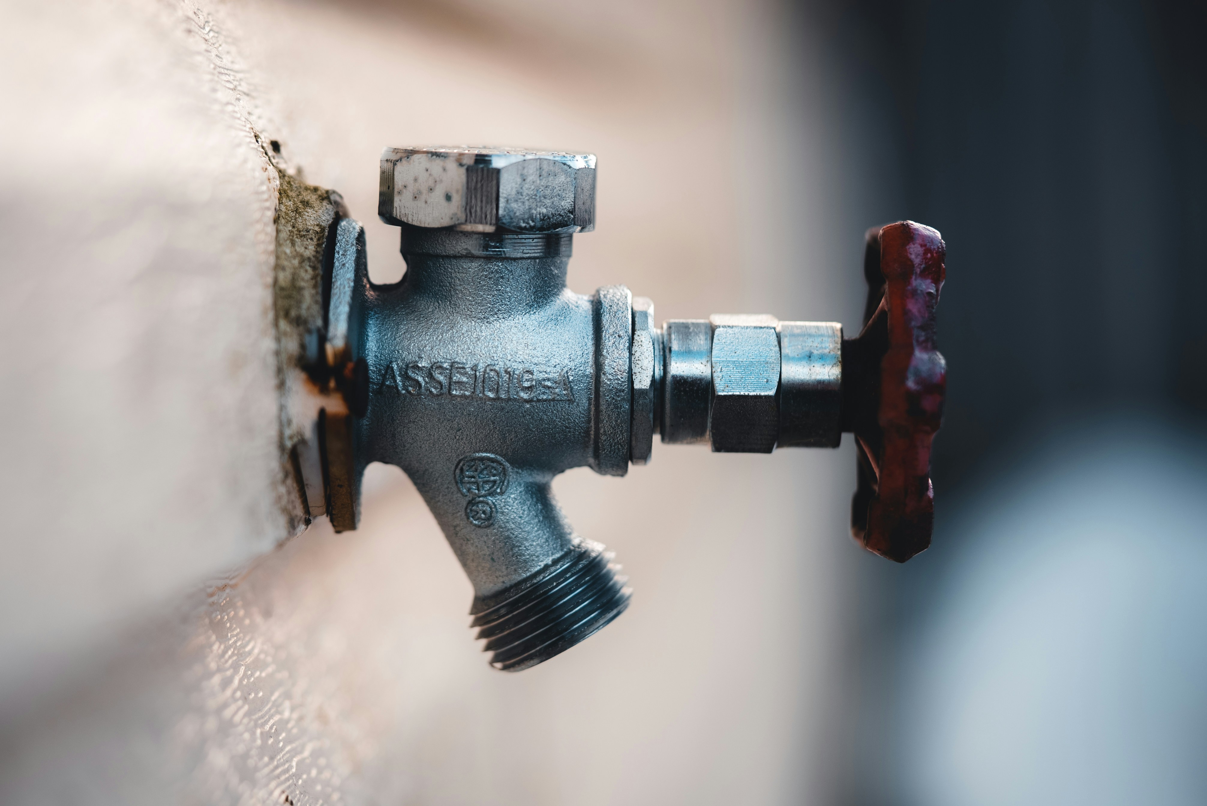 Plumber fixing a kitchen sink with tools